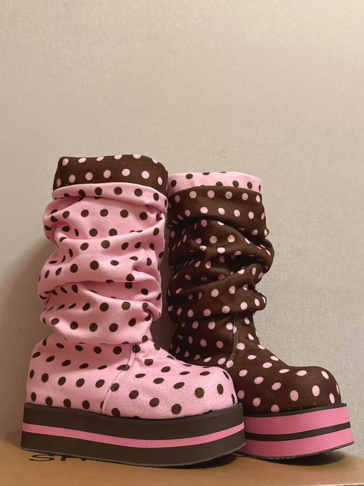 Pink and brown polka dot mofu boots shown as a mismatched pair